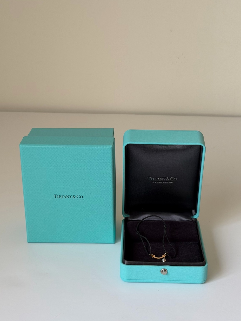 Tiffany & Co. T Smile Bracelet in Rose gold on a black cord